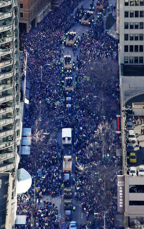 An aerial view shows the procession making its way down Fourth Avenue and shows how the crowd, estimated at 700,000 people, left the sidewalks and thronged the Duck tour boats and military vehicles carrying the Seahawks.
