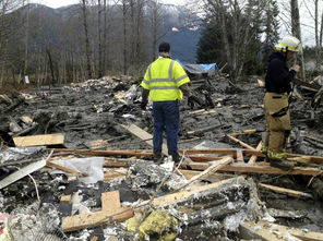 Debris from several buildings and a house in the middle of Highway 530 covered the road in the photo taken by Trooper Mark Francis of the Washington State Patrol shortly after the massive slide occurred. 