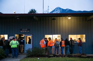 Local residents in boots and protective clothing show up early Tuesday outside the Darrington Fire District 24 station to sign up as volunteer searchers in the disaster area.