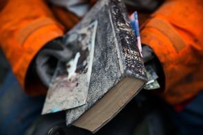 Elaine Young holds a Bible she pulled from the debris left by Saturday’s catastrophic mudslide near Oso, Snohomish County. The hunt for survivors amid the destruction expanded Tuesday, but searchers found no one alive, only more bodies. 