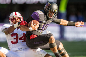 Washington quarterback Cyler Miles (10) gets thrown to the ground by  Stanford’s Peter Kalambayi after a typical short gain on third-and-10 in the fourth quarter.