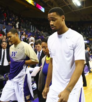 Washington guard Darin Johnson, right, shows his disappointment after  UW lost to Stony Brook, 62-57, in its nonconference finale. It was the Huskies<br/>’ first loss of the season. 