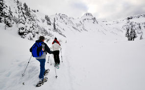 Snowshoers traverse a snowy bowl off the Artist Point trail near Austin Pass in December.