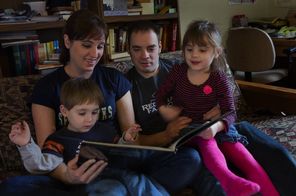  Meg and Jesse Dutcher read to son Bruce, 2, and daughter Julia, 4, at their Federal Way home. The pair lost jobs during the recession.